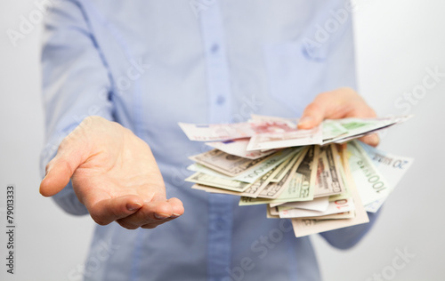 Unrecognizable woman reaching out empty hand and money.