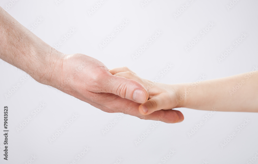 Hands of a child and a father touching each other Hands of a child and a father touching each other