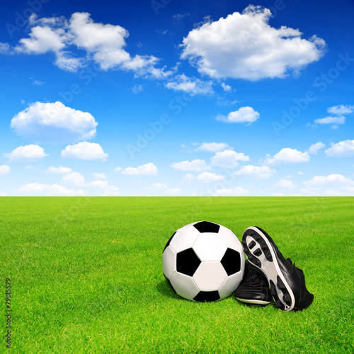 soccer ball and shoes in grass © vencav