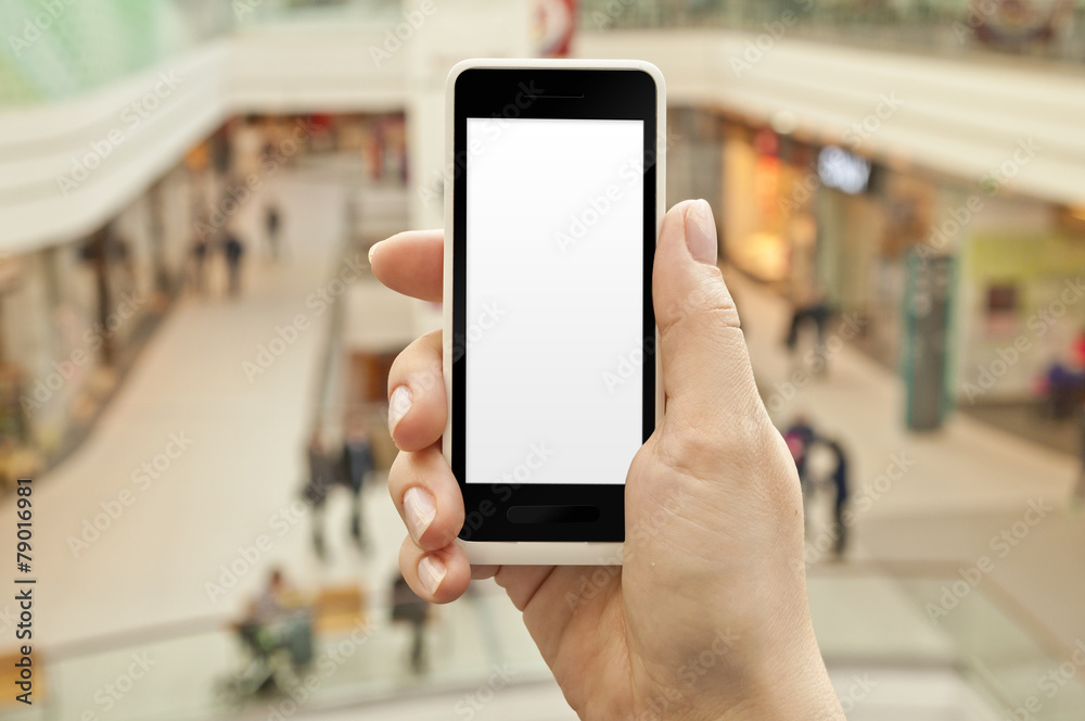 Smartphone with empty screen in woman hand in shopping center