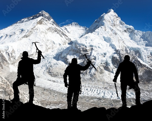 Silhouette of men with ice axe in hand, Mount Everest photo