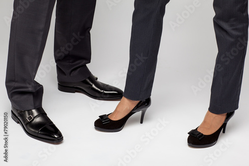 Male and female businessperson's legs