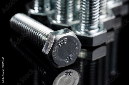 Bolts on the black background. Macro shot.