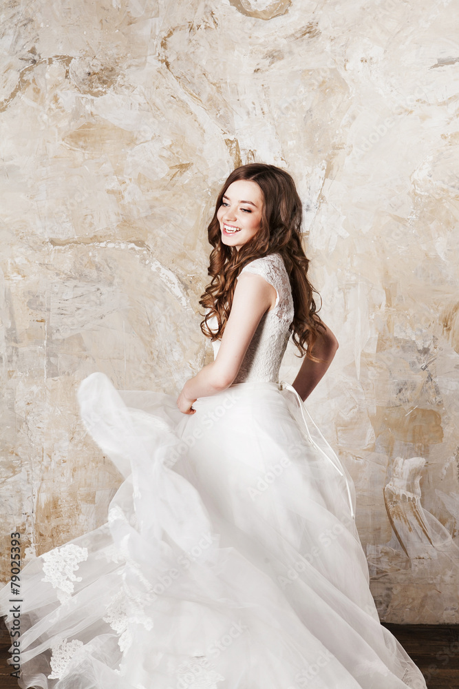 Fototapeta premium Beautiful smiling bride with perfect makeup and hair style in