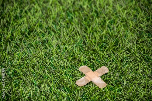 Adhesive plasters sticked to green grass