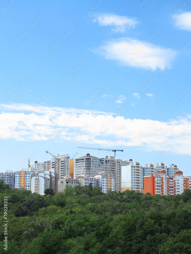 Fototapeta premium Residential modern apartment house, green forest and blue sky
