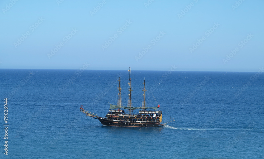 Vintage wooden old ship in blue sea