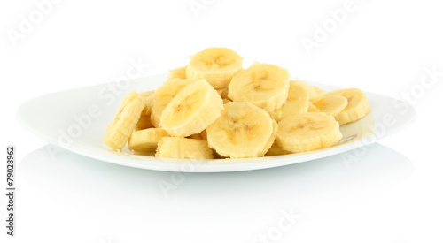 Macro shot of slices of banana on plate on white
