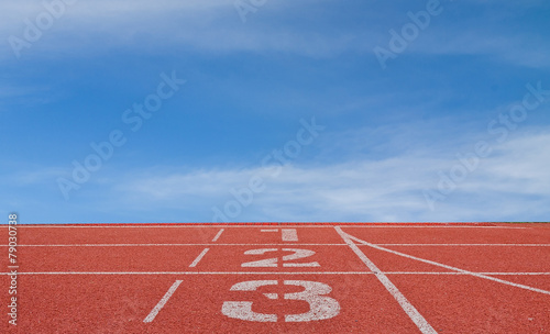 running track number standard red color under the blue sky.
