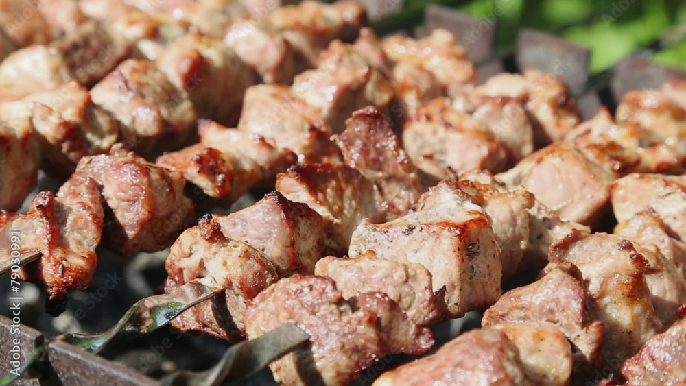 Shashlyk (kebab) grilling on the bbq, closeup view Shashlyk (kebab) grilling on the bbq, closeup view