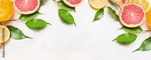 Citrus fruits slices with green leaves, banner