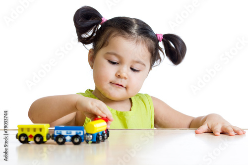 Cute kid girl playing trains