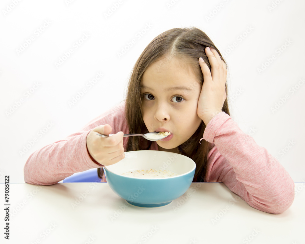 Young girl eating her morning cereal Young girl eating her morning cereal