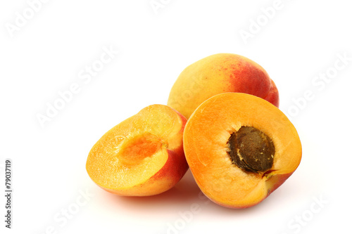 fresh colorful apricot and a cut one on a white background