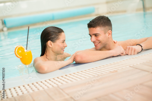 Young couple relaxing in the pool photo