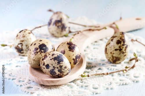 Quail eggs on wooden background closeup.