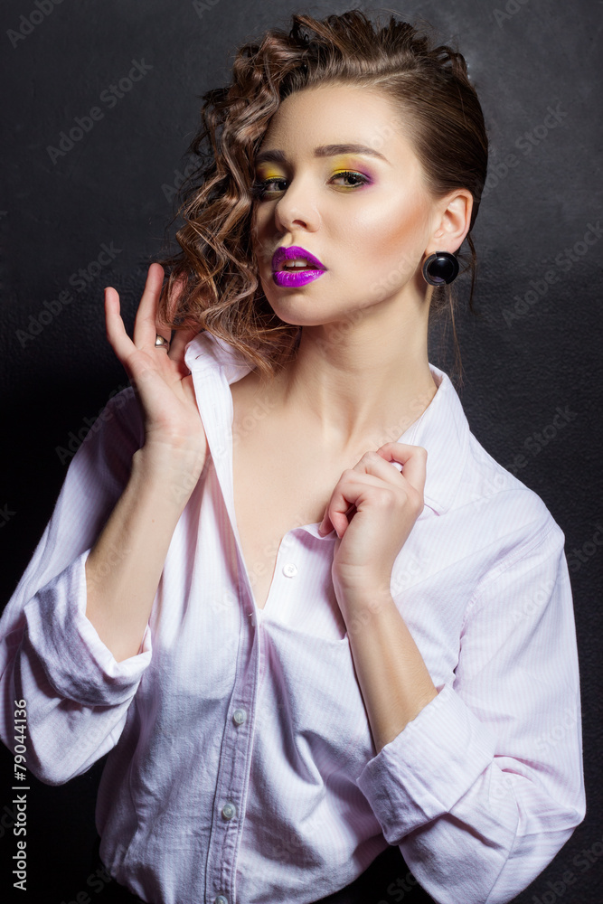 Fototapeta premium sexy girl with bright makeup and beautiful hair in the Studio