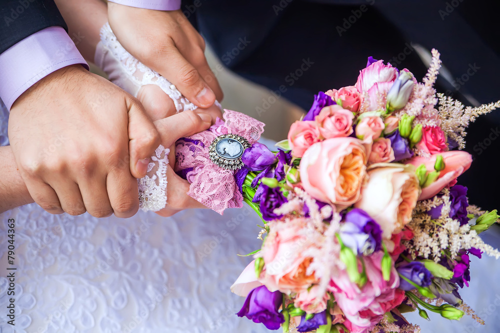 Beautiful wedding bouquet in hands of the bride Beautiful wedding bouquet in hands of the bride