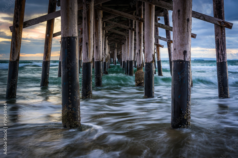 Waves under the pier, in Newport Beach, California.