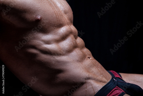 Muscular sexy young naked wet male torso