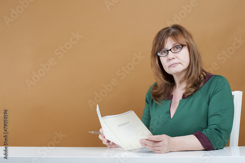 Woman teacher checks the notebook..