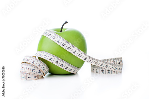 Green apple with measuring tape