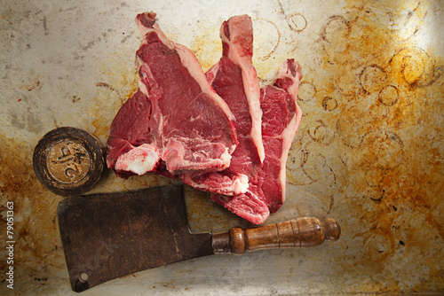 beef steak t-bone with vintage butcher cleaver knife photo