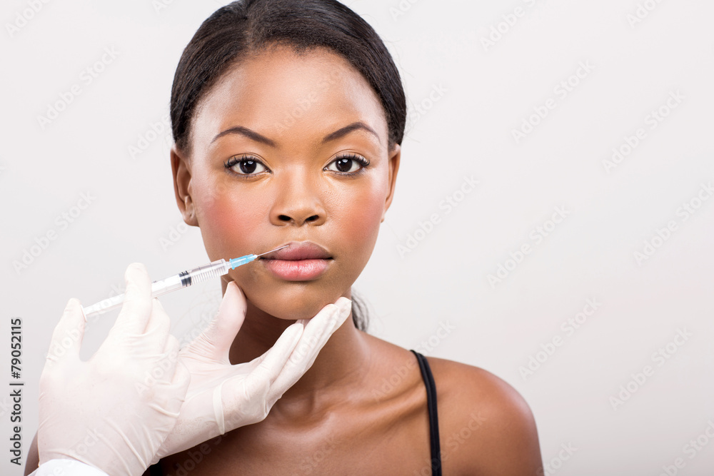 african girl receiving cosmetic injection on her lips african girl receiving cosmetic injection on her lips