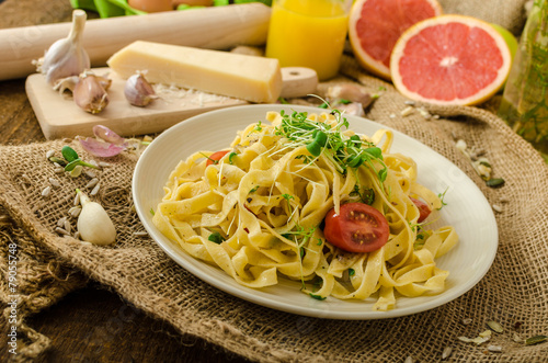 Semolina pasta with roasted garlic, sprinkled microherbs photo