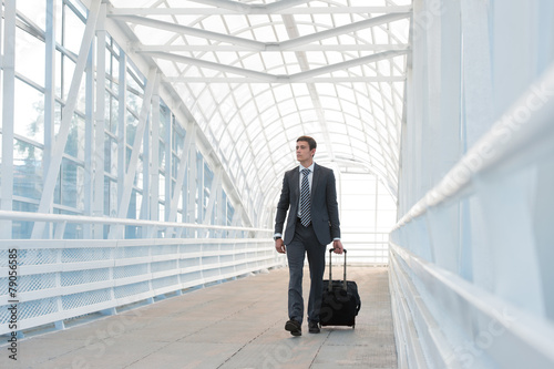 Businessman walking in urban environment of airport