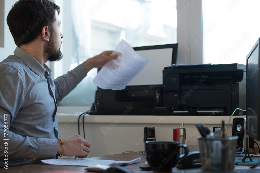 Businessman scanning and printing document Businessman scanning and printing document