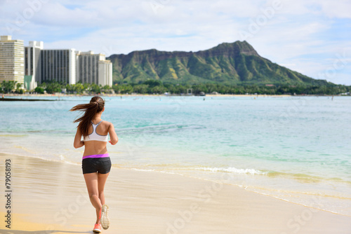 Female runner woman running jogging on beach run © Maridav