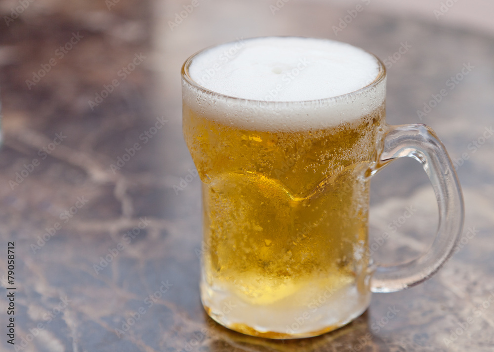 one mug of light beer on the table one mug of light beer on the table