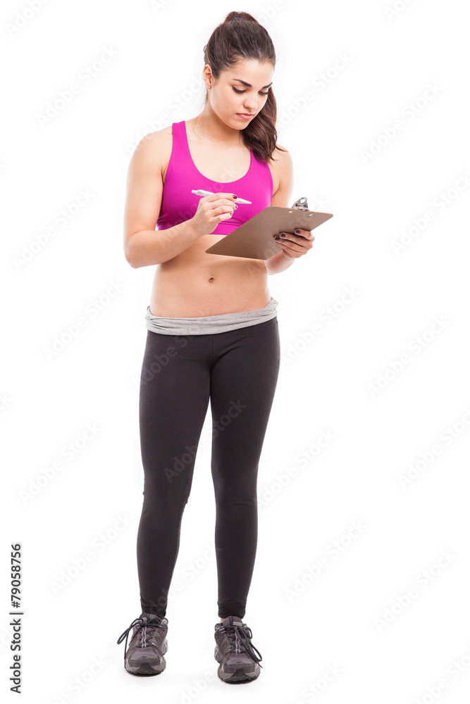 Female trainer taking some notes Female trainer taking some notes