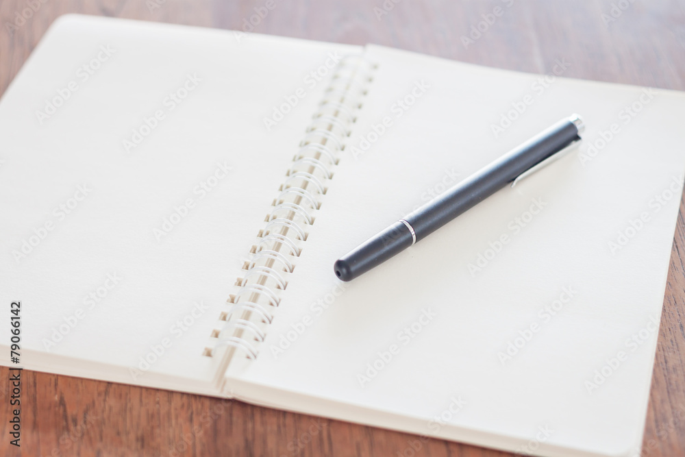 Blank notebook with pen on wooden table Blank notebook with pen on wooden table