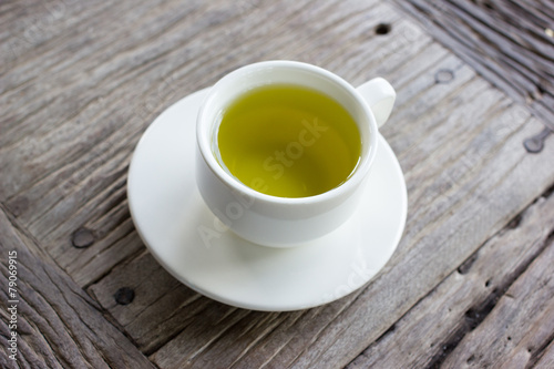 Hot green tea on wood table.