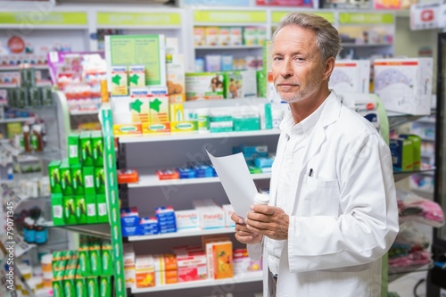 Senior pharmacist holding a prescription