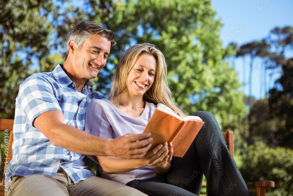 Couple relaxing in the park on bench Couple relaxing in the park on bench