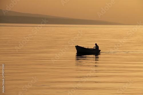 Small boat with beautiful sunset in Brela , Croatia
