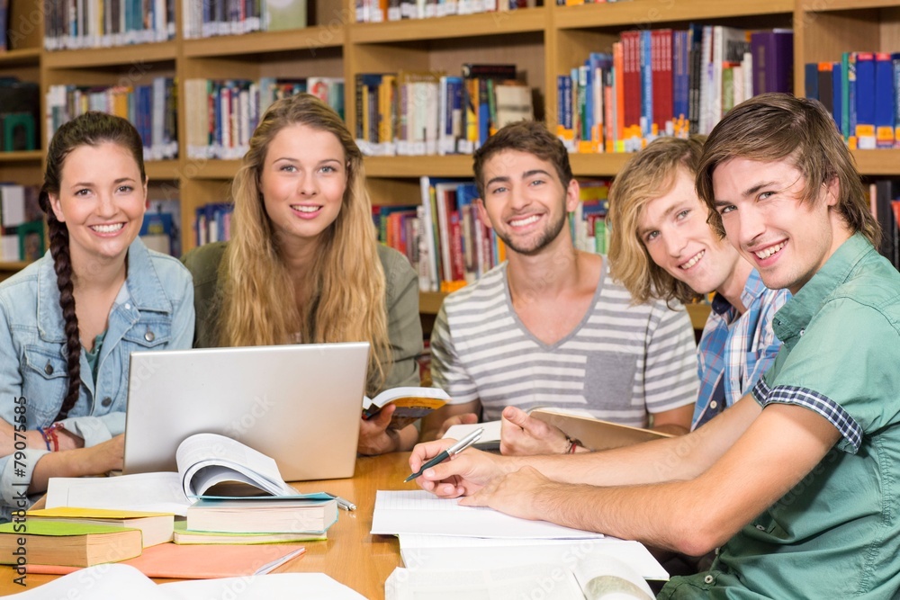 College students doing homework in library College students doing homework in library
