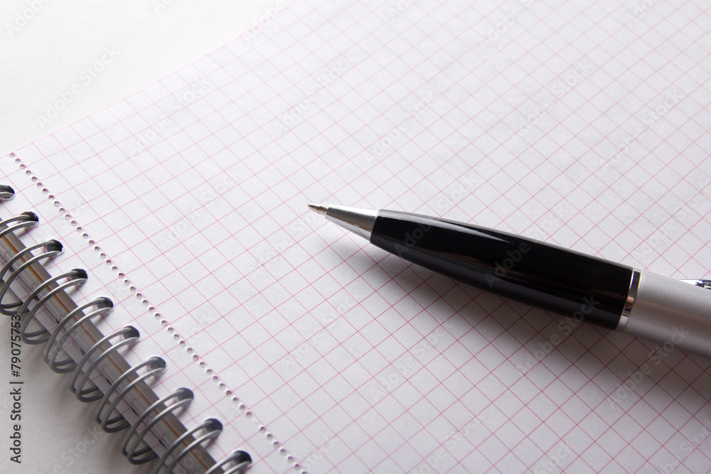close up of note book with checked pages and pen close up of note book with checked pages and pen