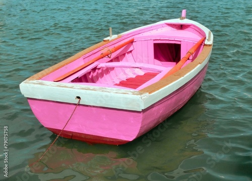 pink boat in the middle of the ocean