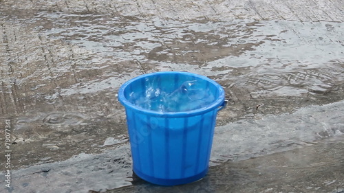 bucket slave rain water flowing down