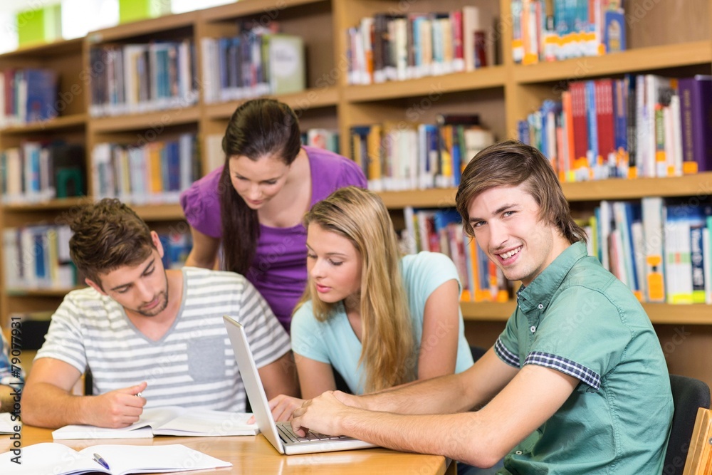 College students doing homework in library College students doing homework in library