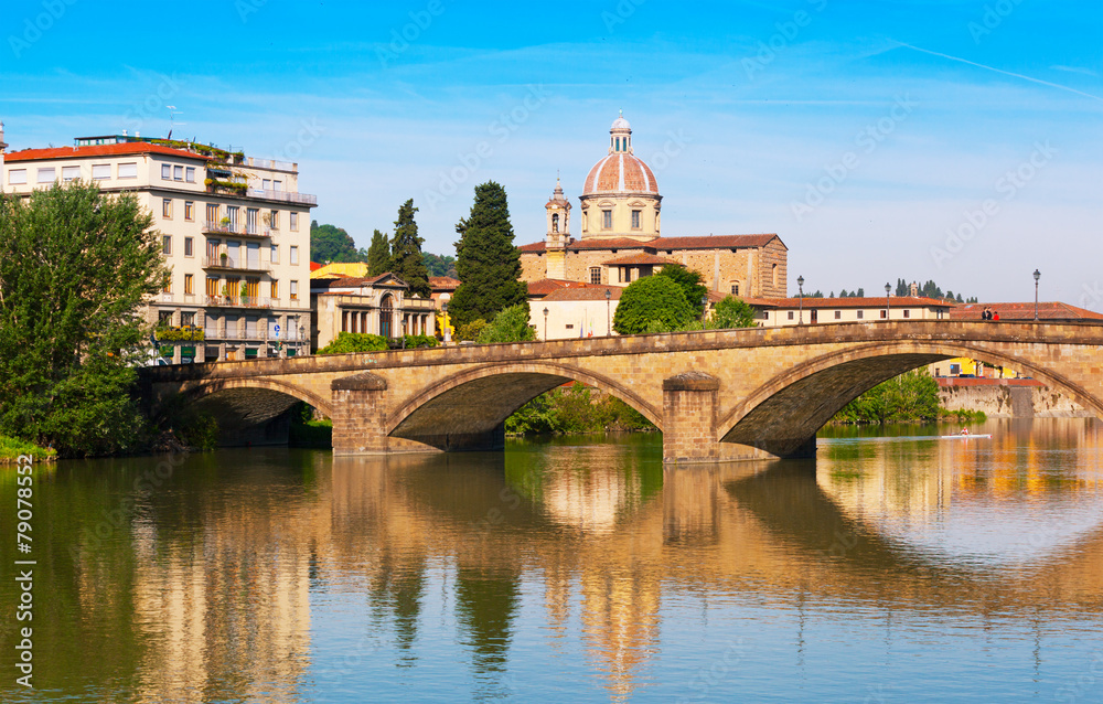 Florence, bridge through the river Arno is reflected in water