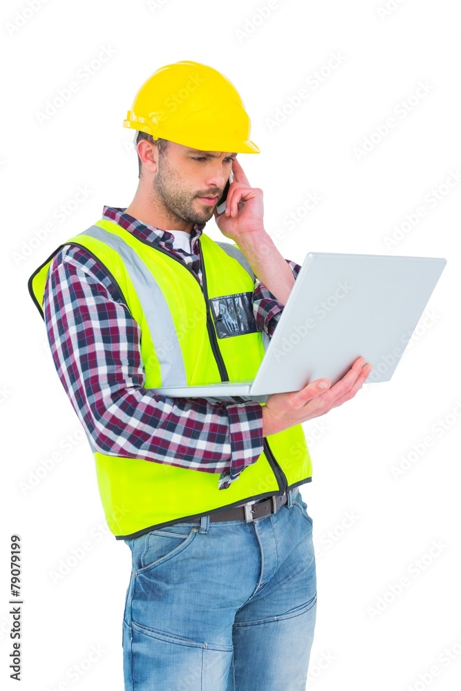 Handyman on the phone holding laptop Handyman on the phone holding laptop