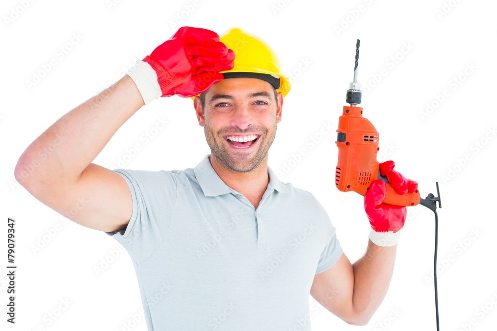 Smiling manual worker holding drill machine Smiling manual worker holding drill machine