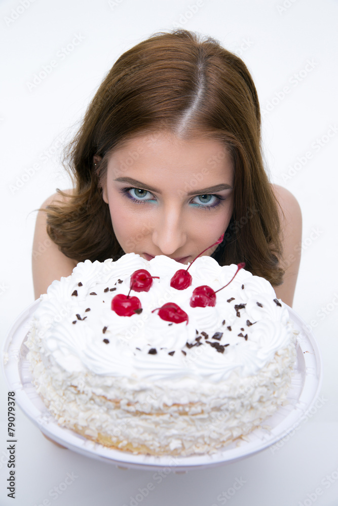 Portrait of a beautiful woman with cake over gray background Portrait of a beautiful woman with cake over gray background