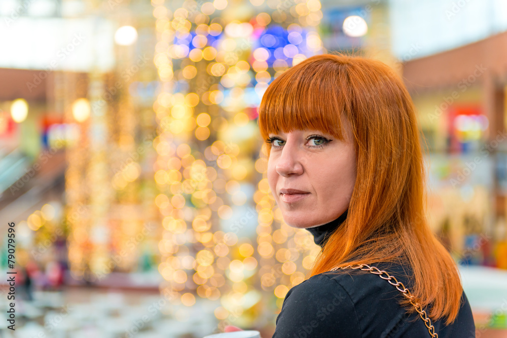 Fototapeta premium portrait of a girl with red hair in the mall