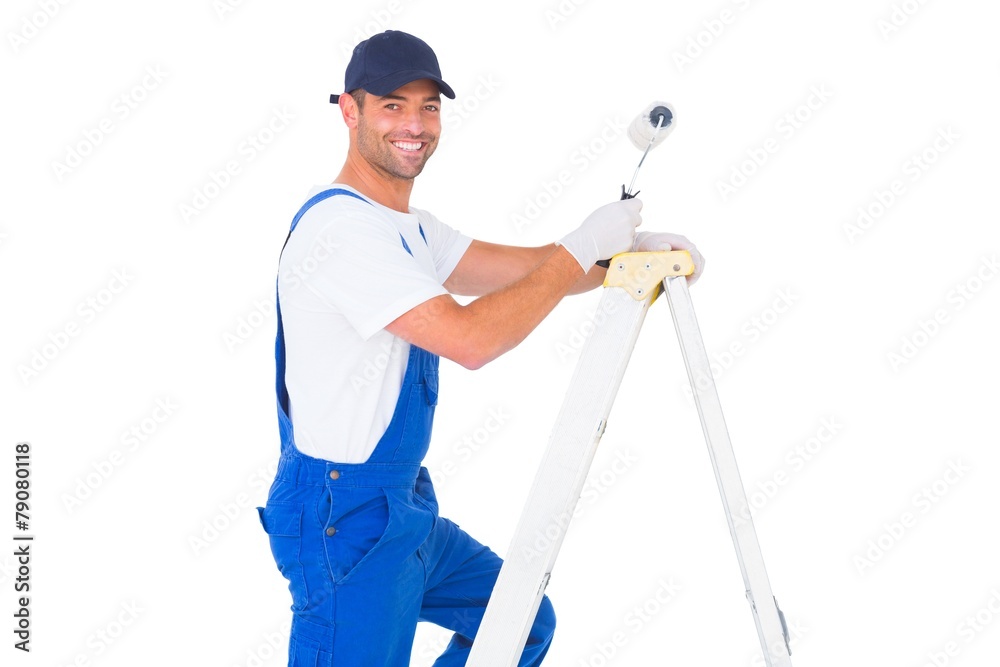 Happy handyman with paint roller climbing ladder Happy handyman with paint roller climbing ladder